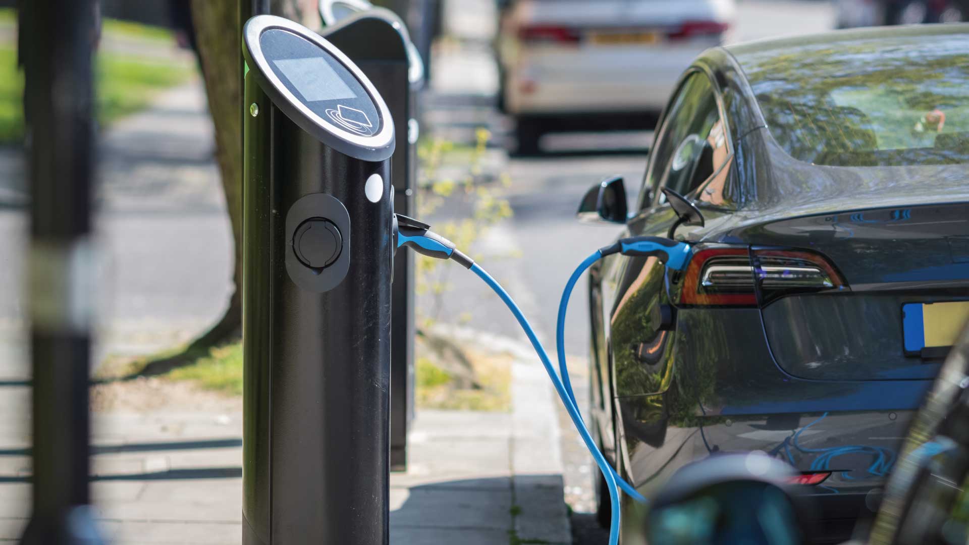 An EV car plugged into a charging station